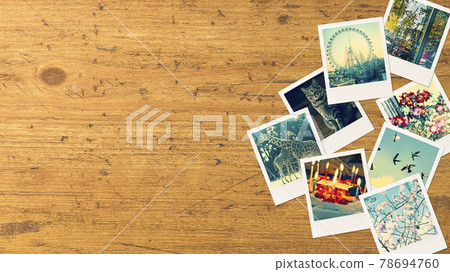 Polaroid photos lined up on an antique wooden table. Angle from directly above Polaroid photos lined up on an antique wooden table. Angle from directly above 78694760