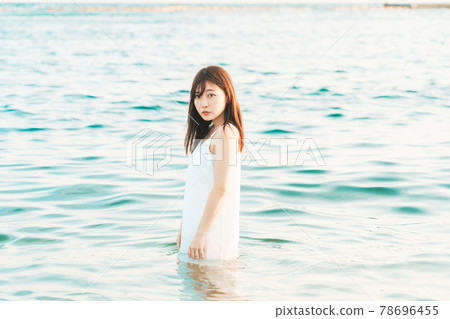 One-piece woman entering the sea One-piece woman entering the sea 78696455