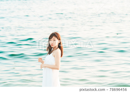 One-piece woman entering the sea 78696456