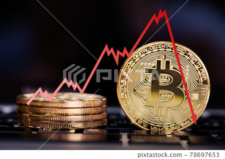 Bitcoin on laptop keyboard with decrease price graphic. Red arrow go down Bitcoin on laptop keyboard with decrease price graphic. Red arrow go down 78697653