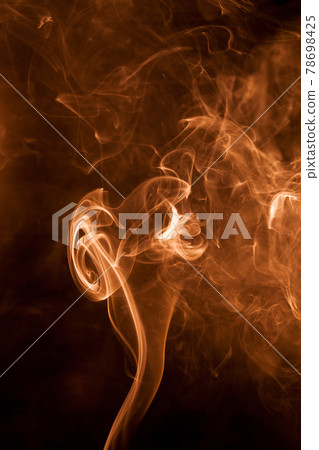 Gold smoke on a black backgroug. Gold smoke on a black backgroug. 78698425