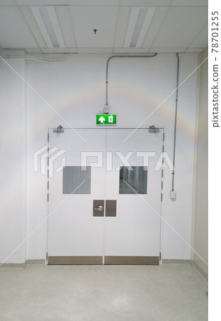 Emergency exit door way with green exit light sign, clean area, walk path way in the GMP factory 78701255