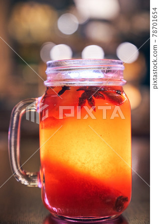 Mulled wine with a straw on the background of the cafe interior 78701654
