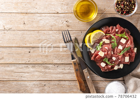 Marbled beef carpaccio on black plate Marbled beef carpaccio on black plate 78706432