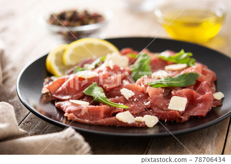 Marbled beef carpaccio on black plate Marbled beef carpaccio on black plate 78706434