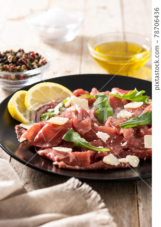 Marbled beef carpaccio on black plate Marbled beef carpaccio on black plate 78706436