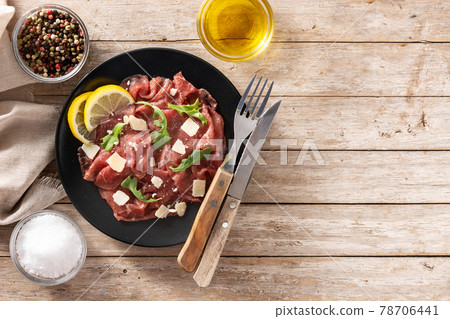 Marbled beef carpaccio on black plate Marbled beef carpaccio on black plate 78706441