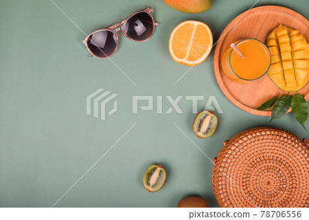 Summer composition. Sunglasses mango, orange, kiwi on green background. Flat lay Summer composition. Sunglasses mango, orange, kiwi on green background. Flat lay 78706556