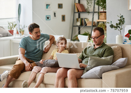 Gay family with daughter resting at home 78707959