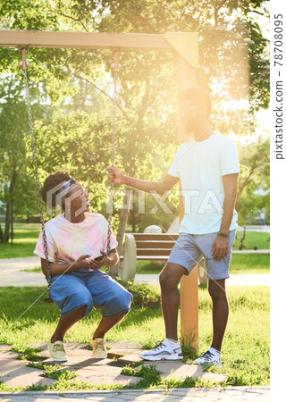 Couple riding on a swing Couple riding on a swing 78708095