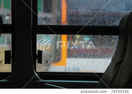 A gloomy and emotional rainy day, looking out the window from inside the car. Raindrops on the window. 78708166