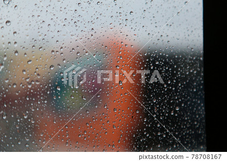 A gloomy and emotional rainy day, looking out the window from inside the car. Raindrops on the window. 78708167