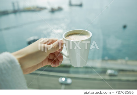 Enjoying morning coffee in the hotel and the sea view outside the window 78708596