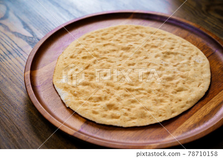 flatbread pita on a round wooden cutting board. bakery. flat bread flatbread pita on a round wooden cutting board. bakery. flat bread 78710158