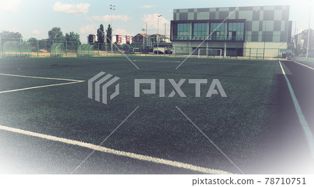 football field with markings. Football stadium. Sports background. Sports center in the city. Vintage or retro style. White vignetting around the edges 78710751