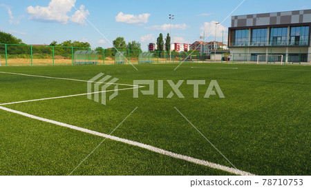 football field with markings. Football stadium. Sports background. Sports center in the city. football field with markings. Football stadium. Sports background. Sports center in the city. 78710753