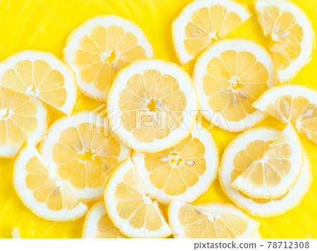Lemon citrus slices in water with ripples, bold yellow texture summer background Lemon citrus slices in water with ripples, bold yellow texture summer background 78712308