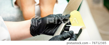 Pedicurist put on new heel file Pedicurist put on new heel file 78712385