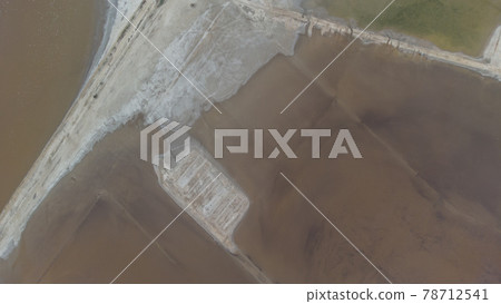 The bottom of a dried up salt lake. View from the air. Traces of cars and motorcycles in the sand. 78712541