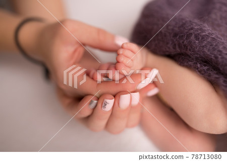 Children's feet in hold hands of mother and father. Mother, father and Child. Happy Family people concept. 78713080