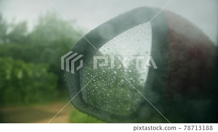Wet rearview mirror of a car on a rainy day Wet rearview mirror of a car on a rainy day 78713188