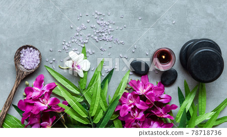 Thai Spa. Top view of hot stones setting for massage treatment and relax with purple orchid Thai Spa. Top view of hot stones setting for massage treatment and relax with purple orchid 78718736