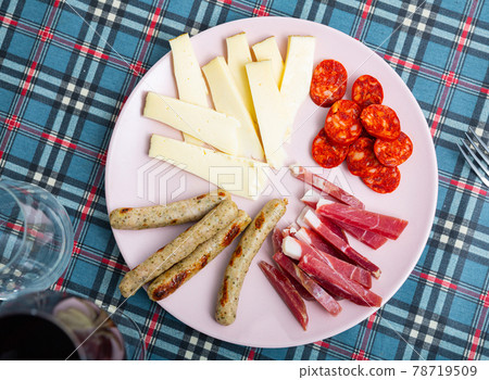 Cold cuts from sausages, cured meat and cheese Cold cuts from sausages, cured meat and cheese 78719509