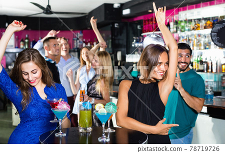 Women are drinking cocktails and having fun in nightclub. Women are drinking cocktails and having fun in nightclub. 78719726