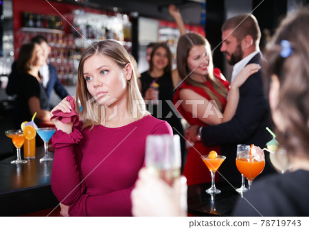 Woman offended while man dancing with another at nightclub Woman offended while man dancing with another at nightclub 78719743