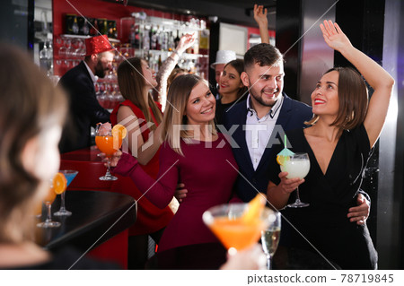 Guy with two girls partying in bar 78719845