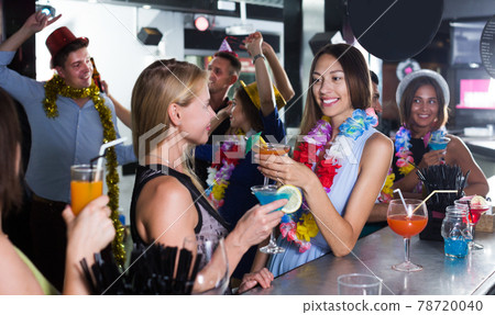 Two female are having fun and drinking cocktails 78720040