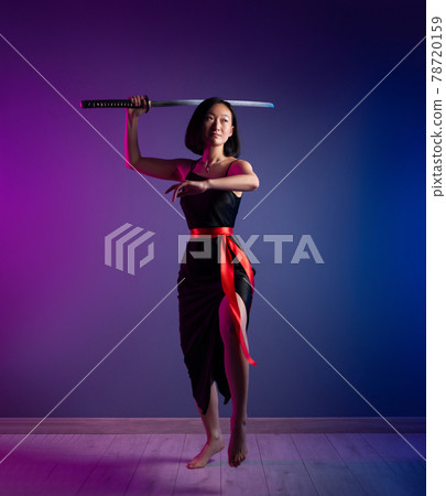 slender Asian woman in a black dress with a katana in her hand image of a samurai on a neon background slender Asian woman in a black dress with a katana in her hand image of a samurai on a neon background 78720159
