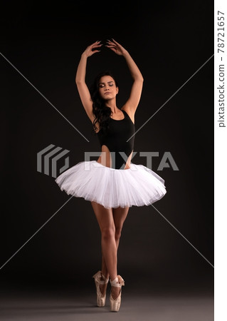 Pretty ballerina in tutu stand on pointess 78721657
