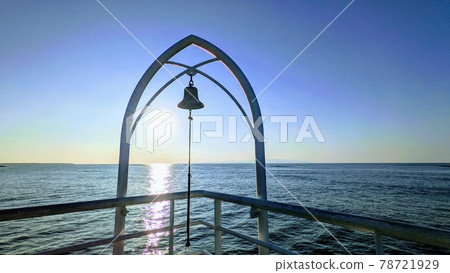 Fusaki Beach pier bell shining in the setting sun 78721929