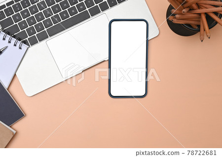 Above view smart phone and laptop computer over on beige background. Above view smart phone and laptop computer over on beige background. 78722681