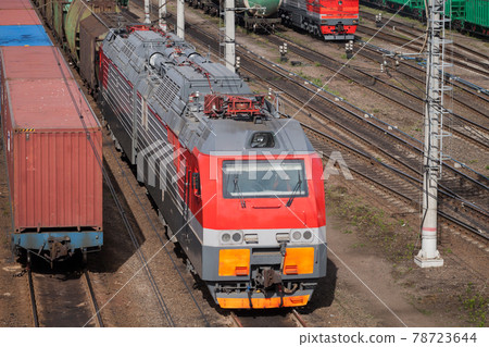 Modern red diesel electric locomotive is on a railway Modern red diesel electric locomotive is on a railway 78723644