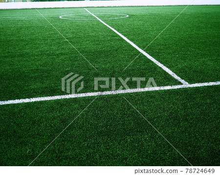 The marking of the football field on the green grass. White lines no more than 12 cm or 5 inches wide. Football field area. 78724649
