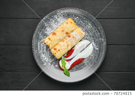 Overhead view of thin crepe with ricotta and strawberry jam 78724815