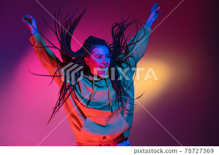Young woman's portrait on gradient colors studio background in neon. Concept of human emotions. Young woman's portrait on gradient colors studio background in neon. Concept of human emotions. 78727369