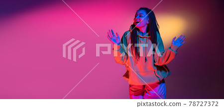 Young woman's portrait on gradient colors studio background in neon. Concept of human emotions. 78727372