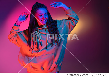 Young woman's portrait on gradient colors studio background in neon. Concept of human emotions. Young woman's portrait on gradient colors studio background in neon. Concept of human emotions. 78727373