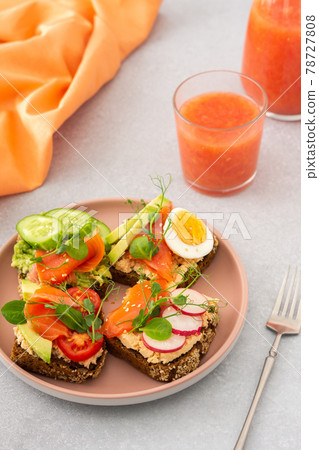 Sandwiches with avocado, salmon and vegetables 78727808