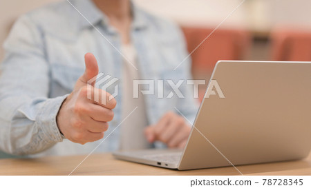 Man showing Thumbs up while using Laptop, Close up Man showing Thumbs up while using Laptop, Close up 78728345