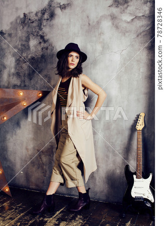 young pretty woman waiting alone in modern loft studio, fashion clothers wearing hat, lifestyle and people home concept young pretty woman waiting alone in modern loft studio, fashion clothers wearing hat, lifestyle and people home concept 78728346