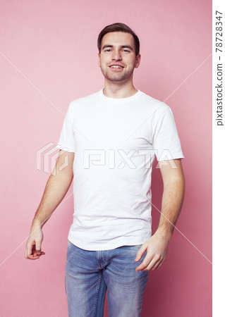 young caucasian guy in white t-shirt posing cheerful on pink background, lifestyle people concept young caucasian guy in white t-shirt posing cheerful on pink background, lifestyle people concept 78728347