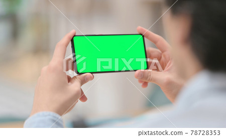 Man Watching Smartphone with Green Chroma Key Screen Man Watching Smartphone with Green Chroma Key Screen 78728353