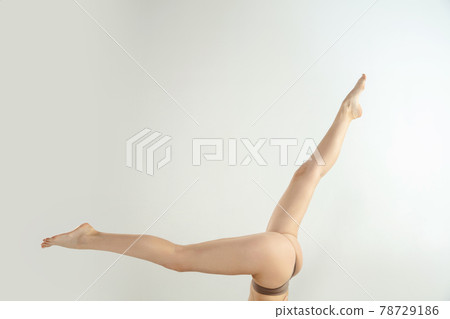 Beautiful female legs isolated on white background. Beauty, cosmetics, spa, depilation, treatment and fitness concept. Fit and sportive, sensual body with well-kept skin in underwear. Beautiful female legs isolated on white background. Beauty, cosmetics, spa, depilation, treatment and fitness concept. Fit and sportive, sensual body with well-kept skin in underwear. 78729186
