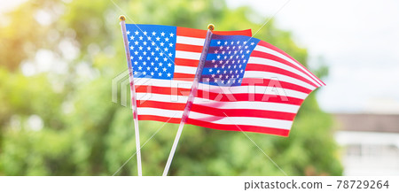 hand holding United States of America flag on green background. USA holiday of Veterans, Memorial, Independence ( Fourth of July) and Labor Day concept hand holding United States of America flag on green background. USA holiday of Veterans, Memorial, Independence ( Fourth of July) and Labor Day concept 78729264