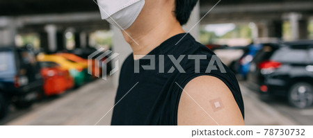 Young vaccinated man showing arms with adhesive plaster bandage after receiving Covid-19 vaccine injection Young vaccinated man showing arms with adhesive plaster bandage after receiving Covid-19 vaccine injection 78730732