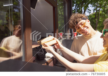 Happy attractive young couple romantically eating a fresh pizza outdoors. 78730805